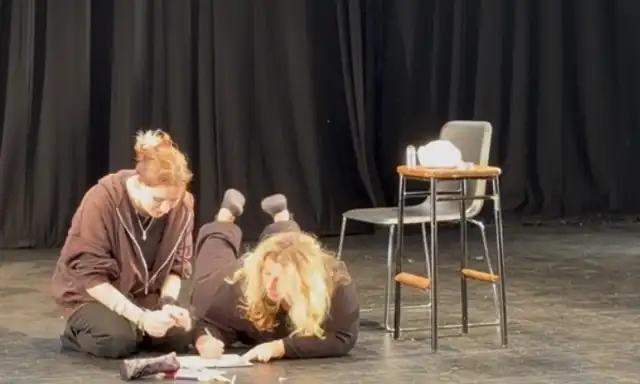 The performers on the stage floor at the end of the scene